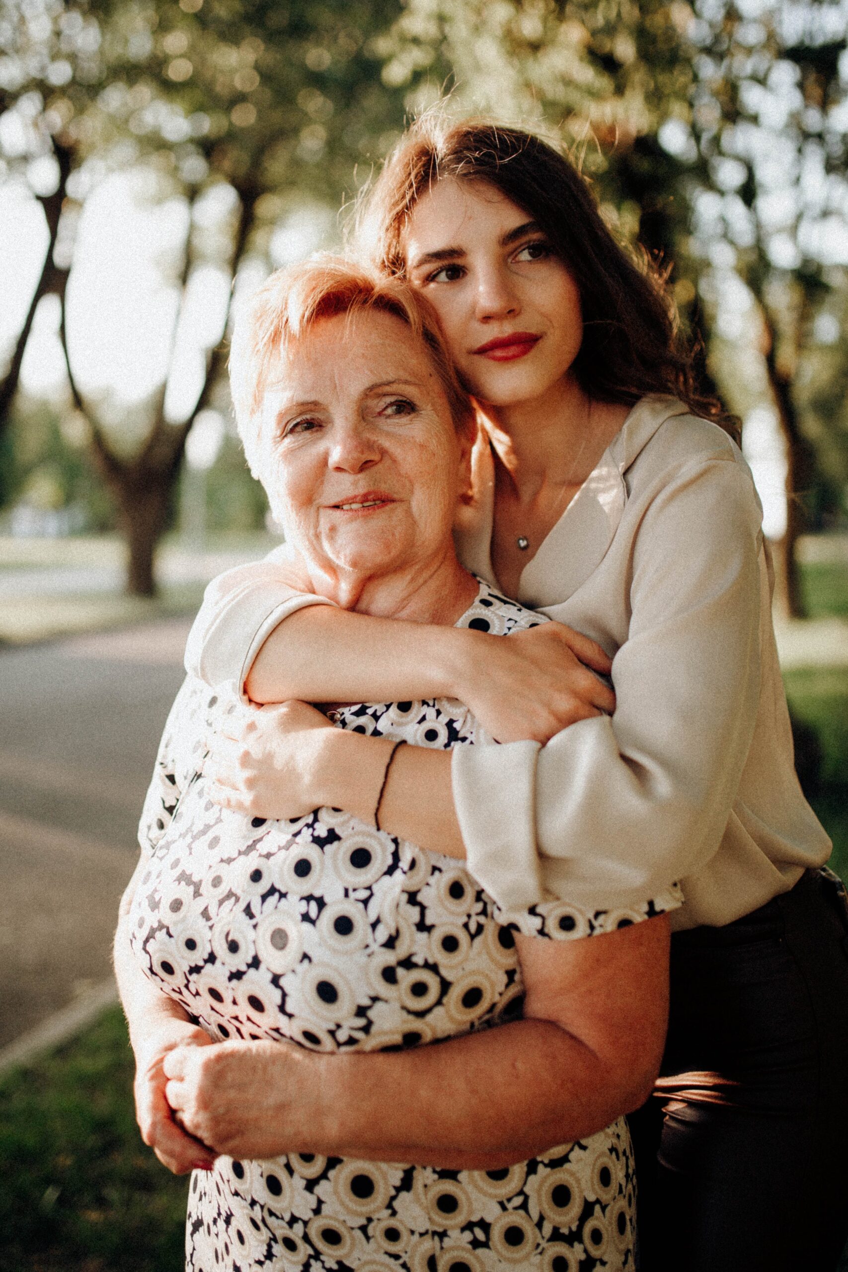A younger woman embracing an older one from behind | Source: Pexels