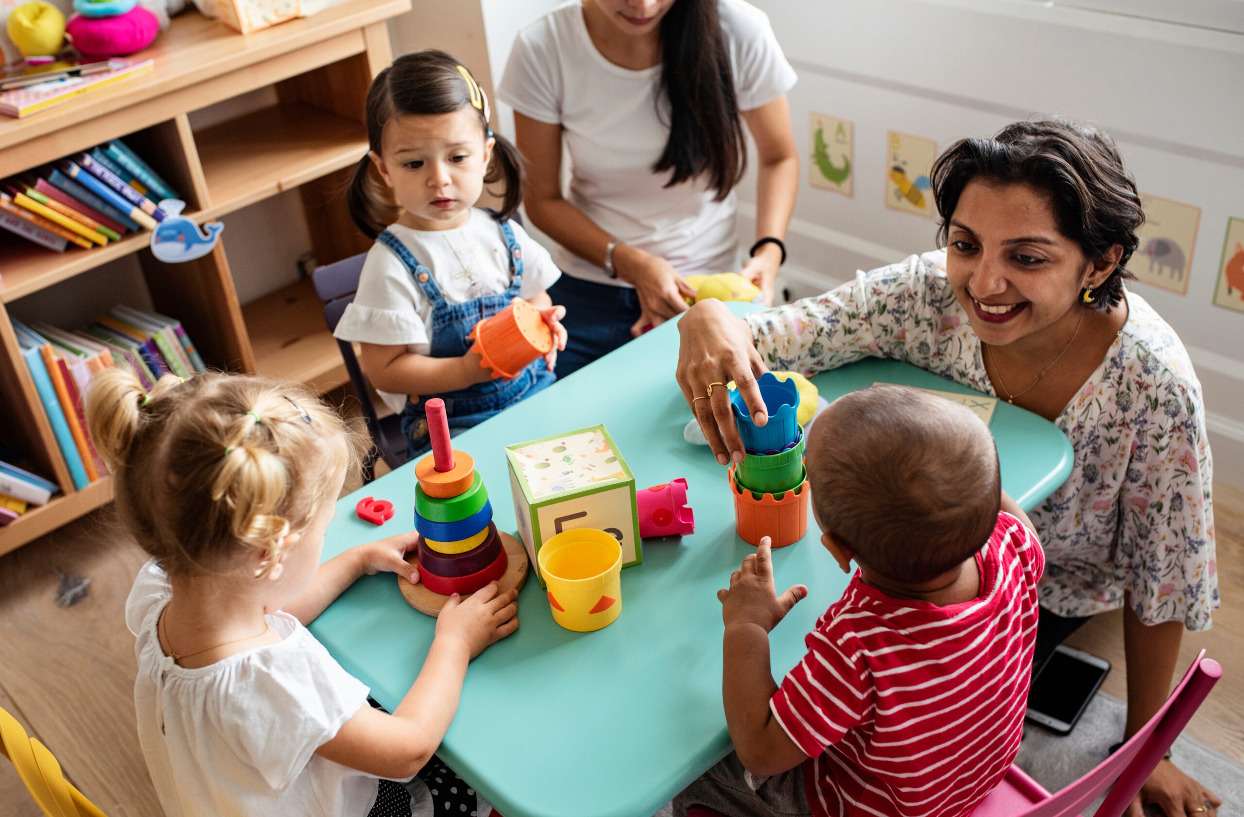 A teacher playing with children at daycare | Source: Shutterstock