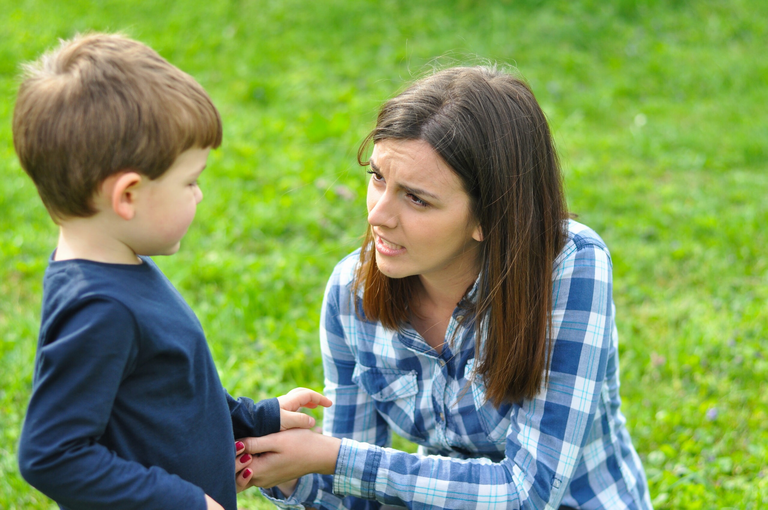 A woman speaking to a little boy | Source: Shutterstock