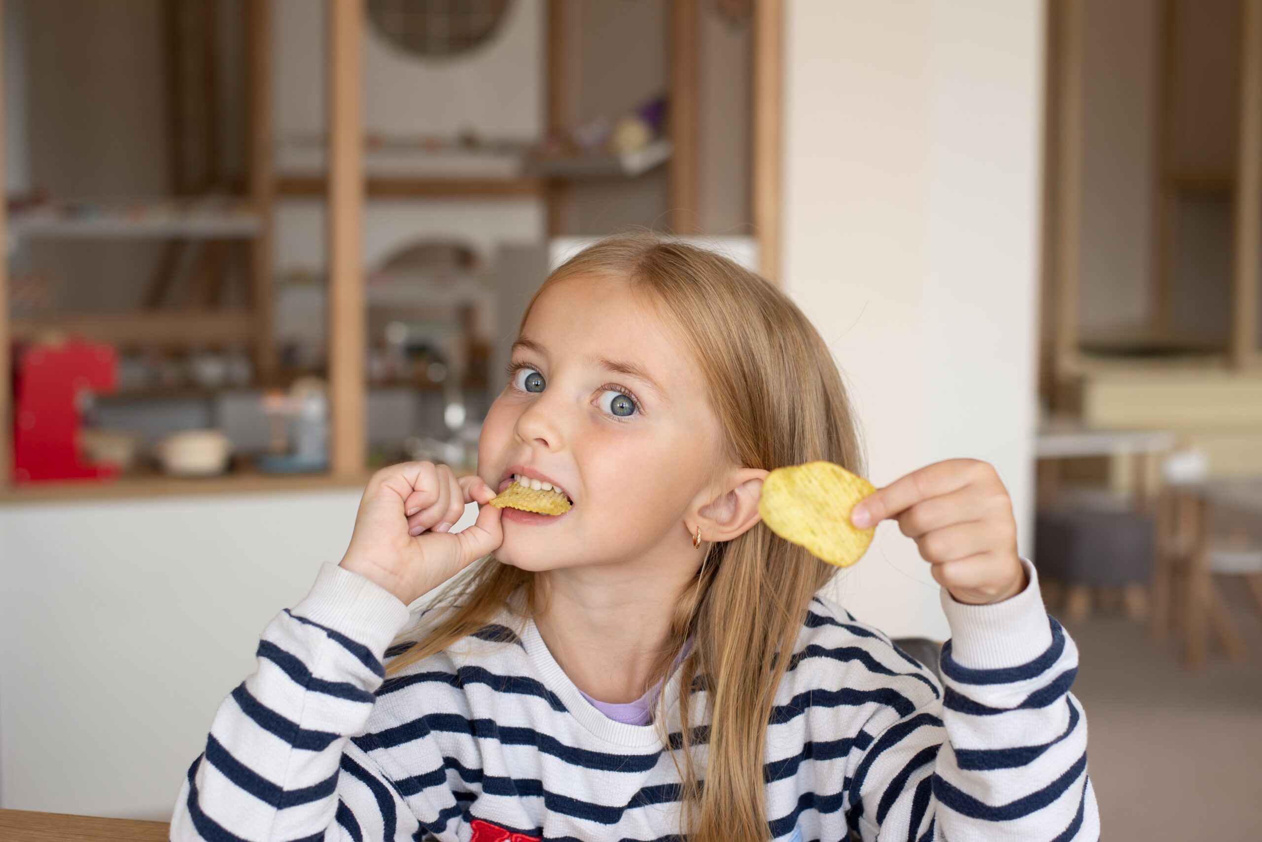 A little girl eating her snacks | Source: Shutterstock