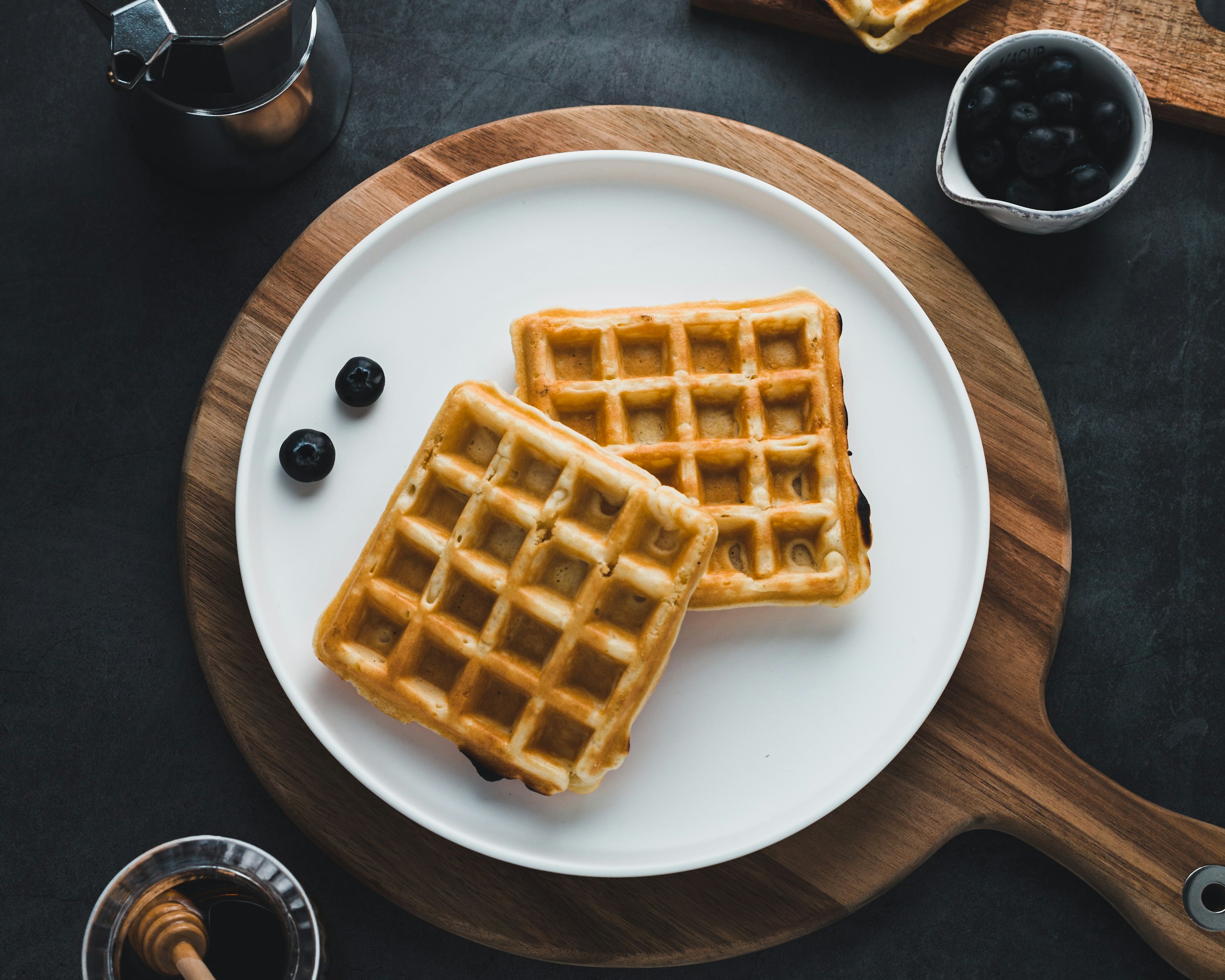 Waffles and blueberries on a plate | Source: Unsplash