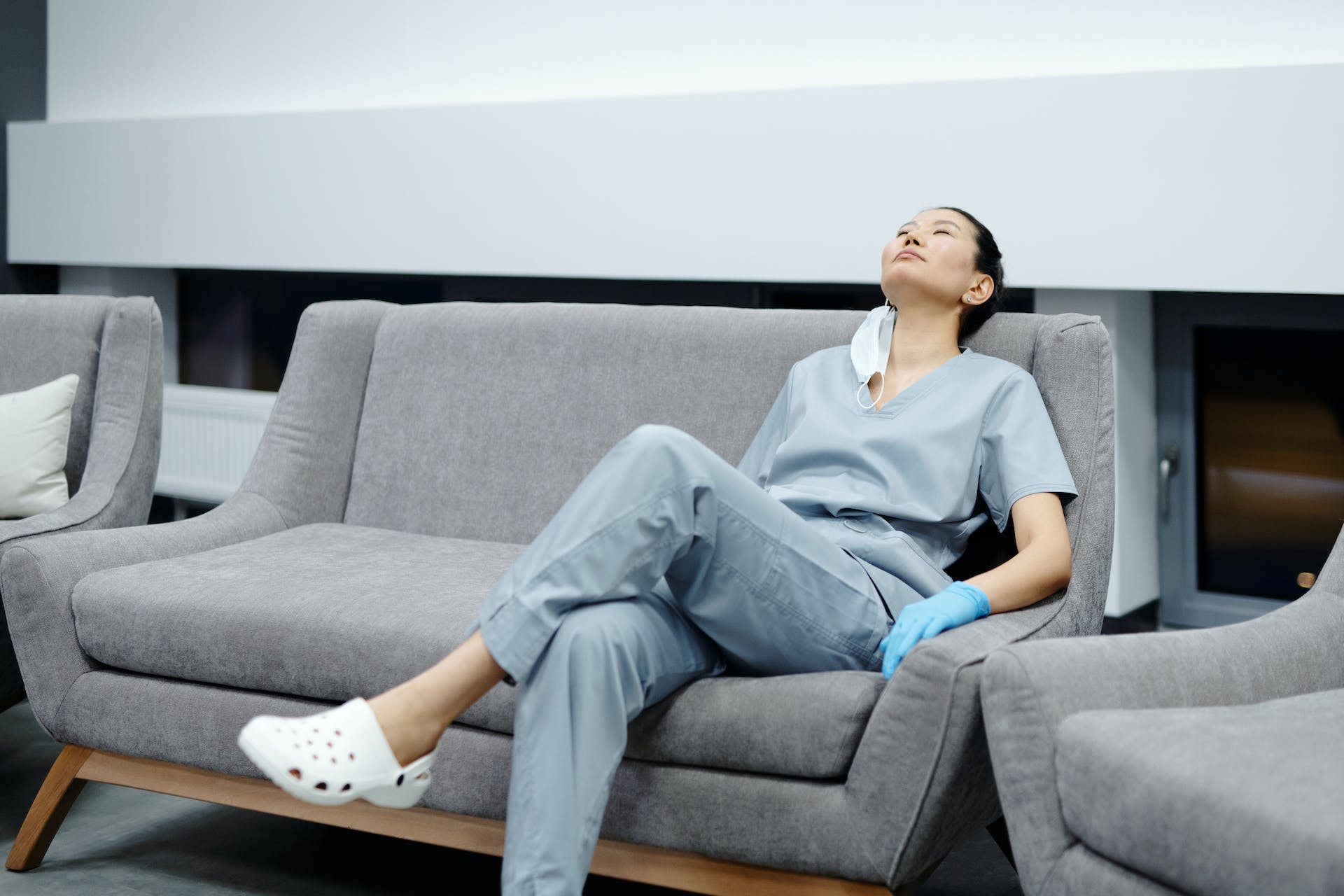 Nurse resting on a couch | Source: Pexels